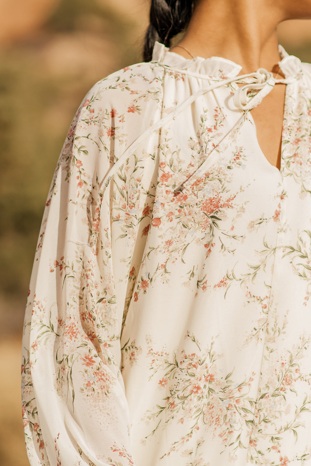 Close up details of cream floral dress, watercolor wildflowers, floral print. bella by grace co