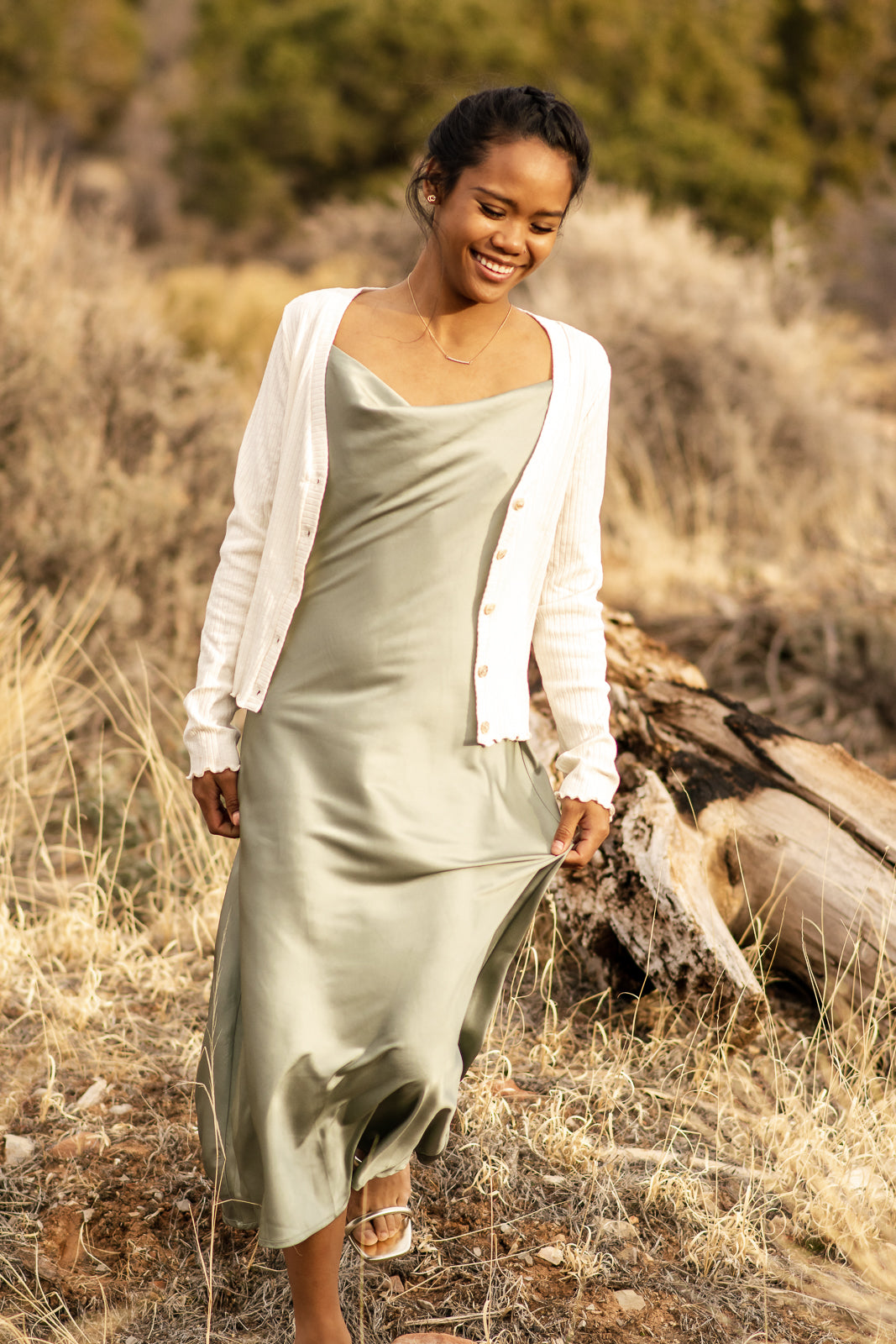 bella by grace co. Women modeling green satin slip dress with a cream cardigan over the dress.