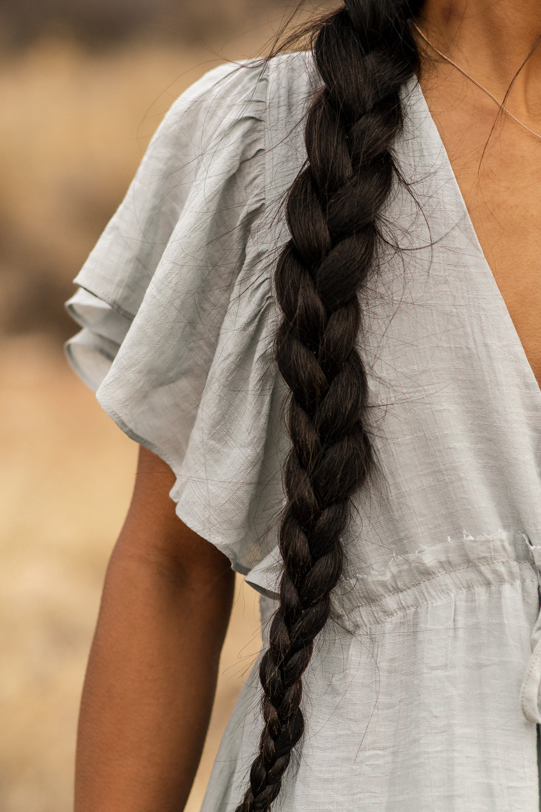 Details of light blue dress, angle sleeved and adjustable waist. bella by grace co.