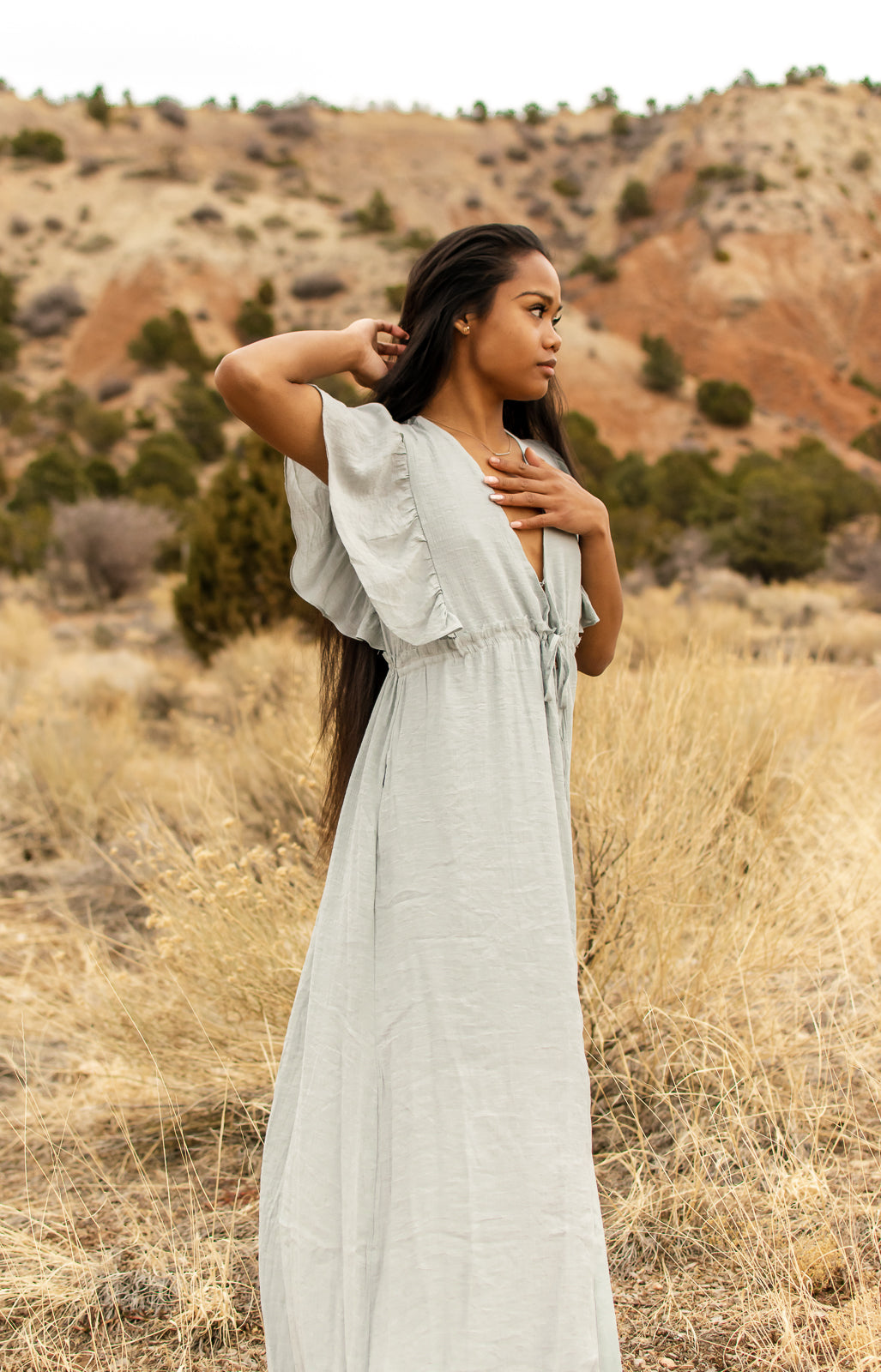 Women modeling a light blue, V-neck, button down, angel sleeve, maxi dress. bella by grace co.